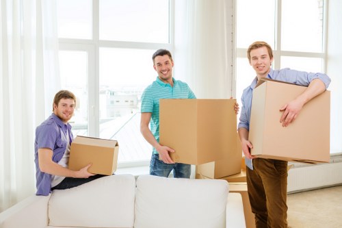 Packers securely packing office equipment for relocation